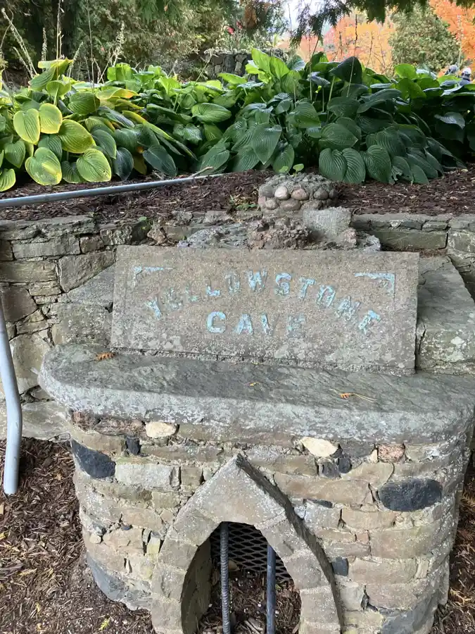 Weathered stone sign reading Yellowstone Cave at Belfountain Conservation Area