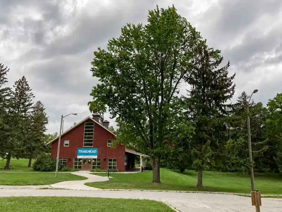 Red Trailhead building surrounded by mature trees at Kelso Conservation Area