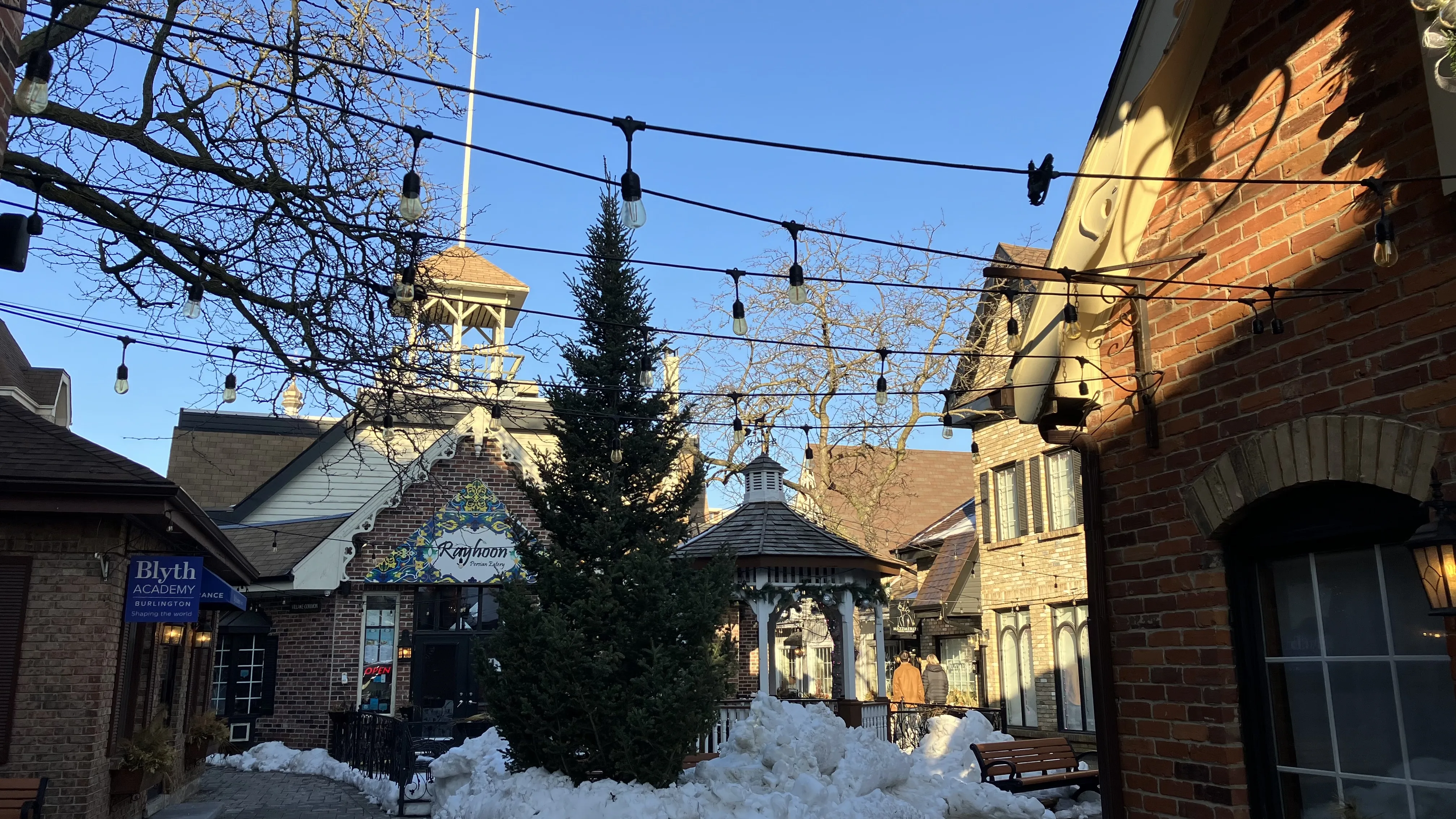 Pátio nevado em Burlington Village Square com fachadas de tijolos