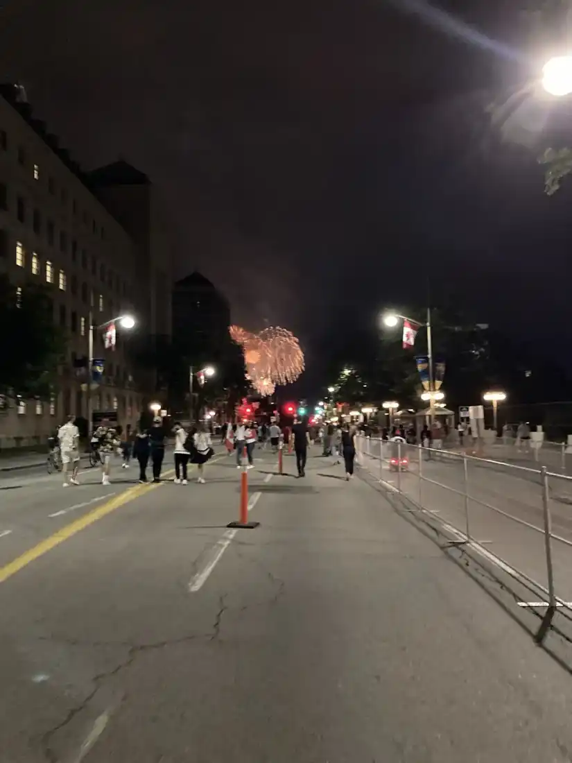 渥太華國會附近嘅夜晚街道，遠處有煙花，路邊有保安圍欄