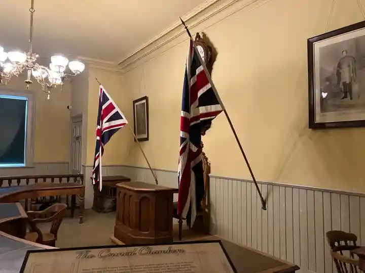 Restored 1879 Council Chambers in Woodstock Museum with Union flags and wooden furniture